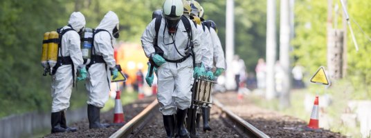 A team working with toxic acids and chemicals is approaching a chemical cargo train crash near Sofia, Bulgaria. Teams from Fire department are participating in an emergency training with spilled toxic and flammable materials.