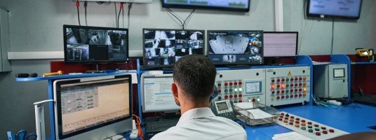 Photo: Server administrator looking after data center rooms through monitors by Iakobchuk at Envato