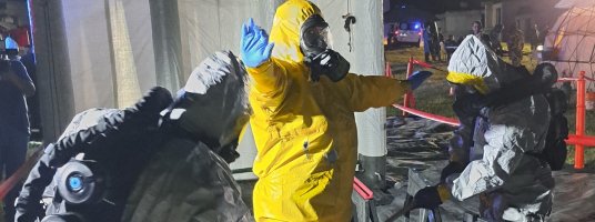 Men in PPE suit - decontamination ©EMBRACE consortium