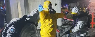 Men in PPE suit - decontamination ©EMBRACE consortium